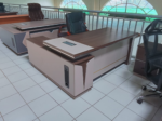 1800MM Executive L-Shaped Desk The 1800MM Executive L-Shaped Desk is a stylish and spacious office workstation designed for executives, managers, and professionals who need a practical and organized working environment. Its L-shaped configuration provides generous workspace for computers, documents, office accessories, and daily business activities. Designed to maximize corner space, this 1800MM L-shaped office desk provides an efficient workstation while maintaining a professional appearance. The extended desktop gives users room to separate computer equipment from paperwork, helping create a cleaner and more productive workspace. The executive design adds a sophisticated touch to modern offices. Its spacious layout is suitable for executive offices, management rooms, corporate workplaces, home offices, and other professional environments where functionality and presentation matter. Key Features 1800MM spacious desktop for comfortable working L-shaped configuration for efficient use of office space Executive-style design for a professional appearance Generous surface for computers, monitors, documents, and accessories