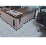 1800MM Executive L-Shaped Desk The 1800MM Executive L-Shaped Desk is a stylish and spacious office workstation designed for executives, managers, and professionals who need a practical and organized working environment. Its L-shaped configuration provides generous workspace for computers, documents, office accessories, and daily business activities. Designed to maximize corner space, this 1800MM L-shaped office desk provides an efficient workstation while maintaining a professional appearance. The extended desktop gives users room to separate computer equipment from paperwork, helping create a cleaner and more productive workspace. The executive design adds a sophisticated touch to modern offices. Its spacious layout is suitable for executive offices, management rooms, corporate workplaces, home offices, and other professional environments where functionality and presentation matter. Key Features 1800MM spacious desktop for comfortable working L-shaped configuration for efficient use of office space Executive-style design for a professional appearance Generous surface for computers, monitors, documents, and accessories