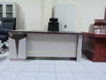 1800MM Executive L-Shaped Desk The 1800MM Executive L-Shaped Desk is a stylish and spacious office workstation designed for executives, managers, and professionals who need a practical and organized working environment. Its L-shaped configuration provides generous workspace for computers, documents, office accessories, and daily business activities. Designed to maximize corner space, this 1800MM L-shaped office desk provides an efficient workstation while maintaining a professional appearance. The extended desktop gives users room to separate computer equipment from paperwork, helping create a cleaner and more productive workspace. The executive design adds a sophisticated touch to modern offices. Its spacious layout is suitable for executive offices, management rooms, corporate workplaces, home offices, and other professional environments where functionality and presentation matter. Key Features 1800MM spacious desktop for comfortable working L-shaped configuration for efficient use of office space Executive-style design for a professional appearance Generous surface for computers, monitors, documents, and accessories