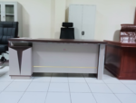 1800MM Executive L-Shaped Desk The 1800MM Executive L-Shaped Desk is a stylish and spacious office workstation designed for executives, managers, and professionals who need a practical and organized working environment. Its L-shaped configuration provides generous workspace for computers, documents, office accessories, and daily business activities. Designed to maximize corner space, this 1800MM L-shaped office desk provides an efficient workstation while maintaining a professional appearance. The extended desktop gives users room to separate computer equipment from paperwork, helping create a cleaner and more productive workspace. The executive design adds a sophisticated touch to modern offices. Its spacious layout is suitable for executive offices, management rooms, corporate workplaces, home offices, and other professional environments where functionality and presentation matter. Key Features 1800MM spacious desktop for comfortable working L-shaped configuration for efficient use of office space Executive-style design for a professional appearance Generous surface for computers, monitors, documents, and accessories